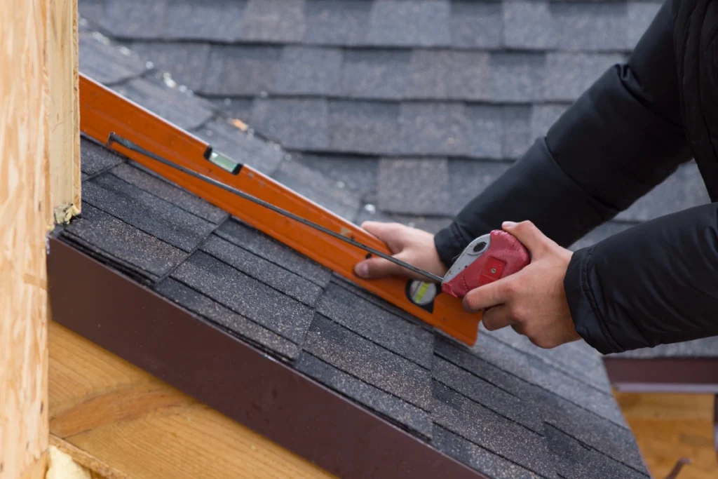 measure roof-using hand tools to measure roof for shingles