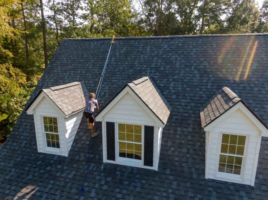 inspector on house roof in a safety harness