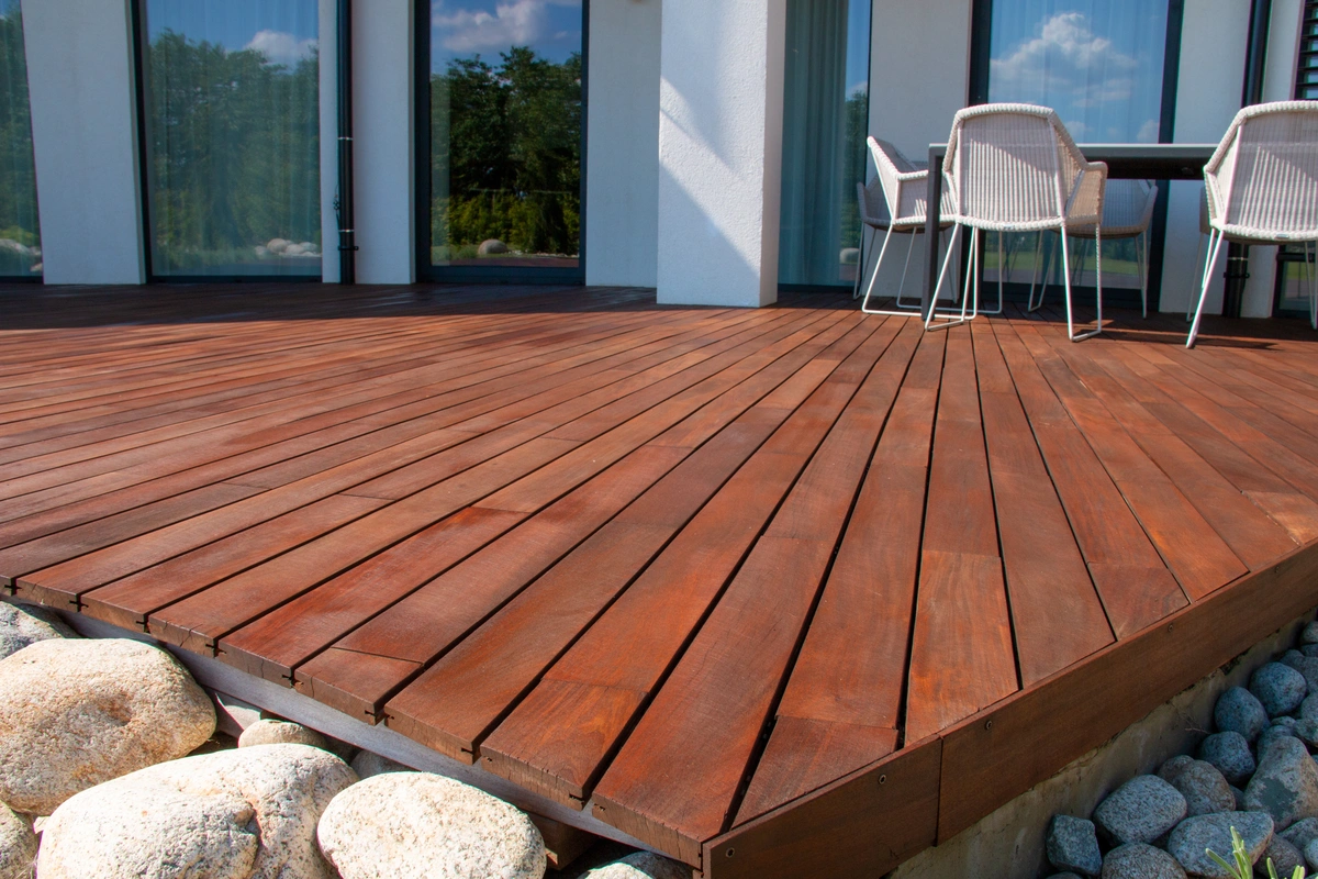 decks molalla-dark wood decking built off the main house with decorative rocks around the edge
