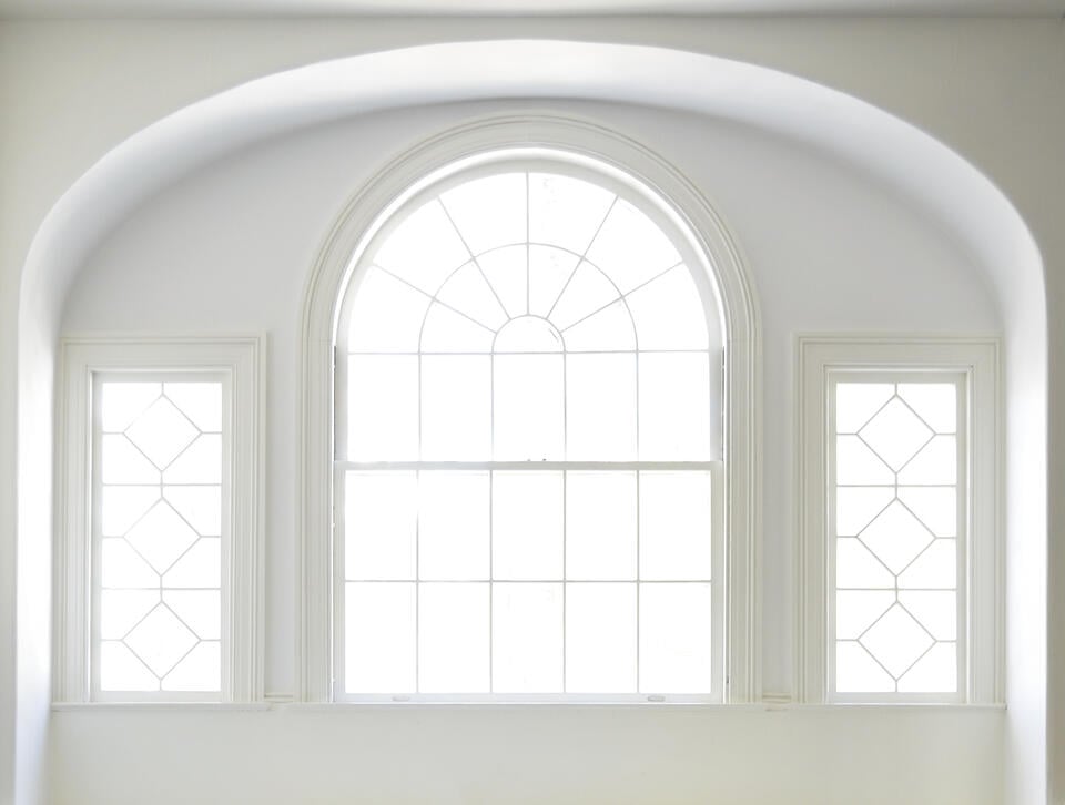 arched window-white walls and trim surrounding arched window