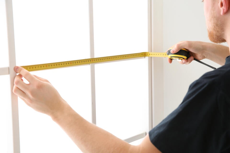 how to measure for replacement windows-man measuring grilles of window