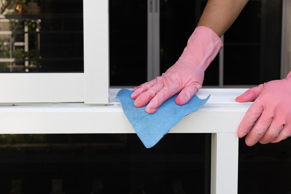 window sash-gloved hand cleaning window sash