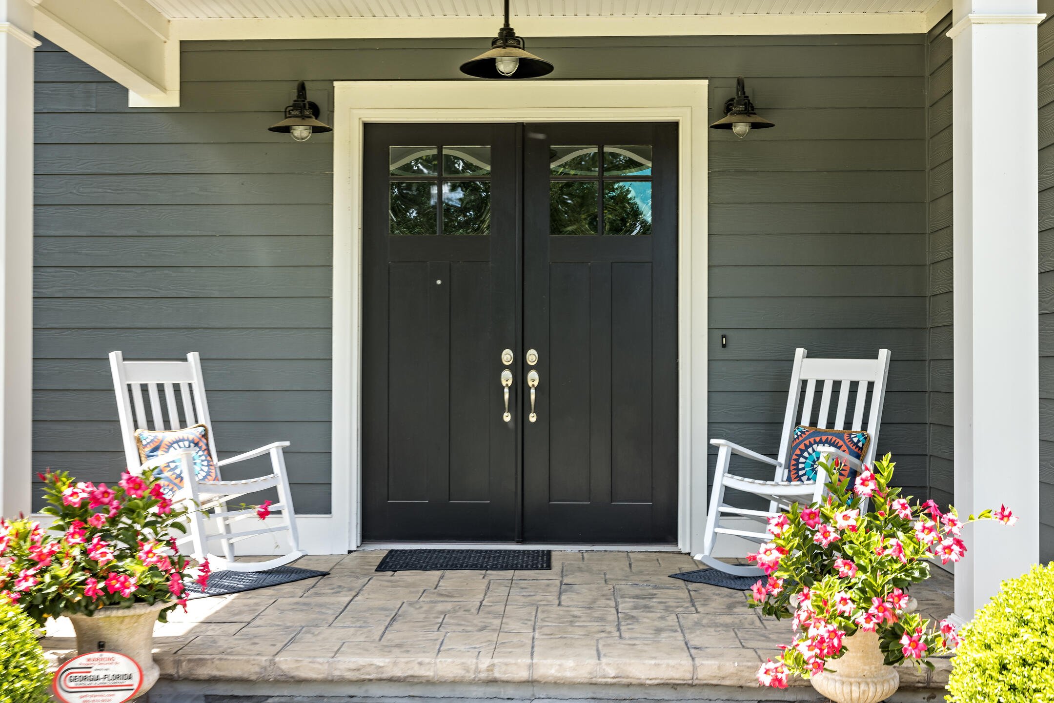 double front doors-black double front doors with silver hardware on grayish sided house