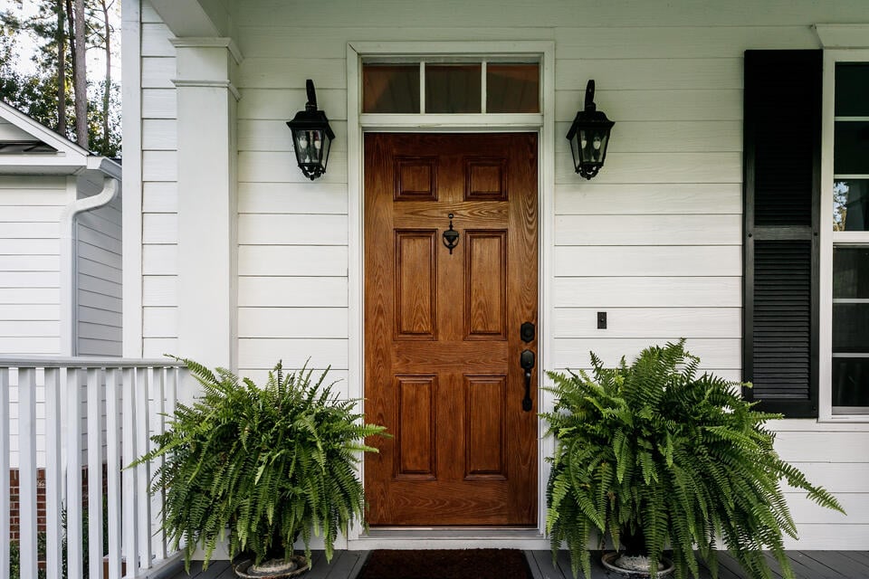 how much does a door cost-front wooden door on white sided house
