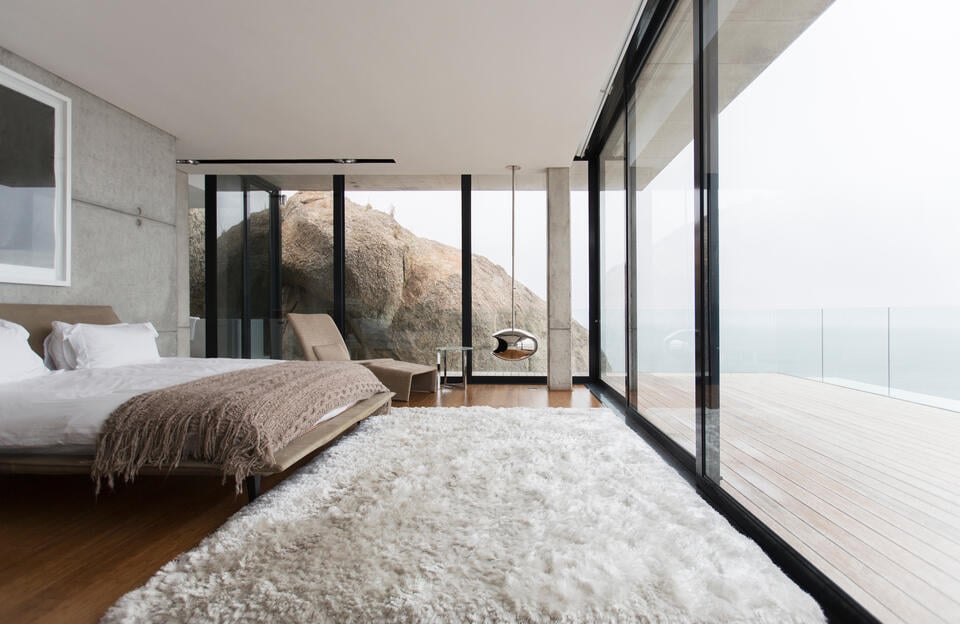 modern windows-coastal bedroom with floor to ceiling windows along two entire walls