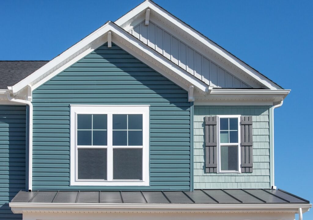 Blue green fiber cement siding installed on family home