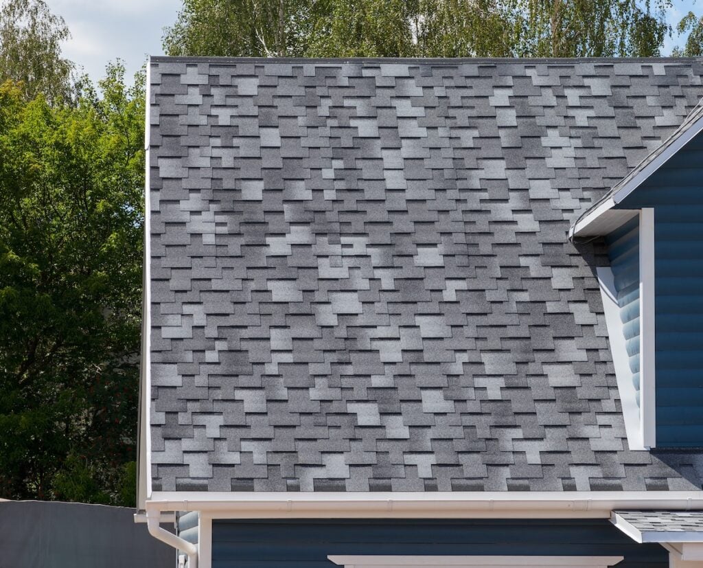 The roof of the house lined with architectural shingles