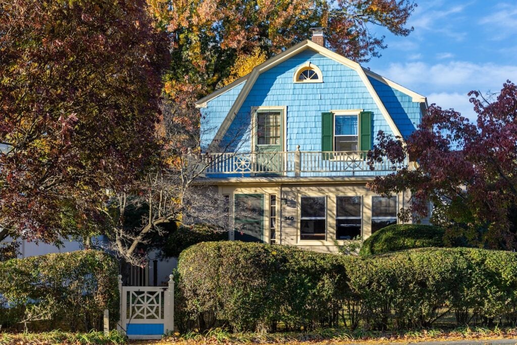 Blue house with gambrel roof view from the front yard