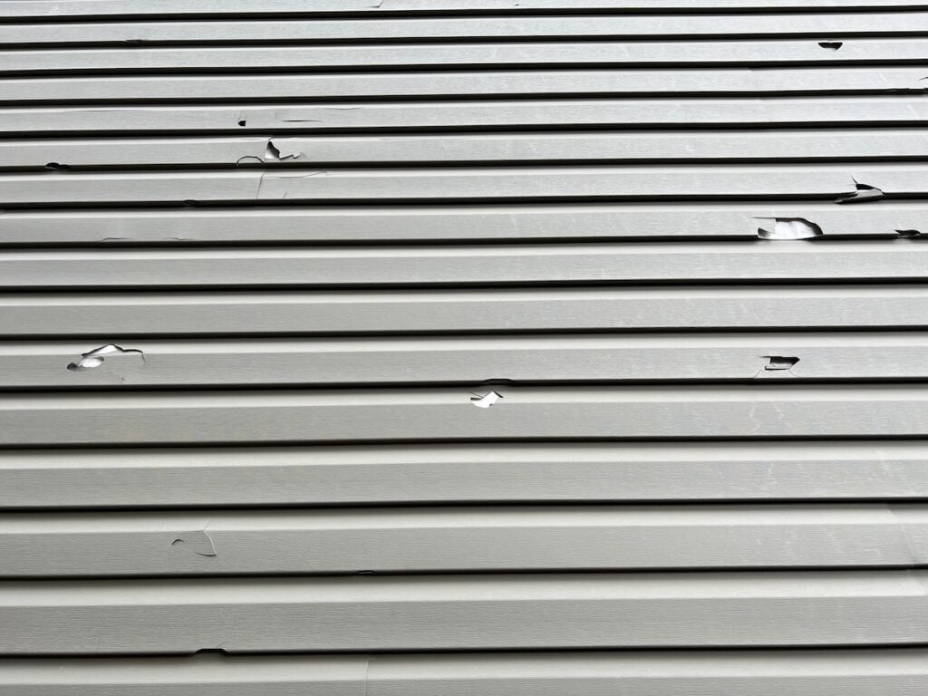 Cracked siding with missing pieces