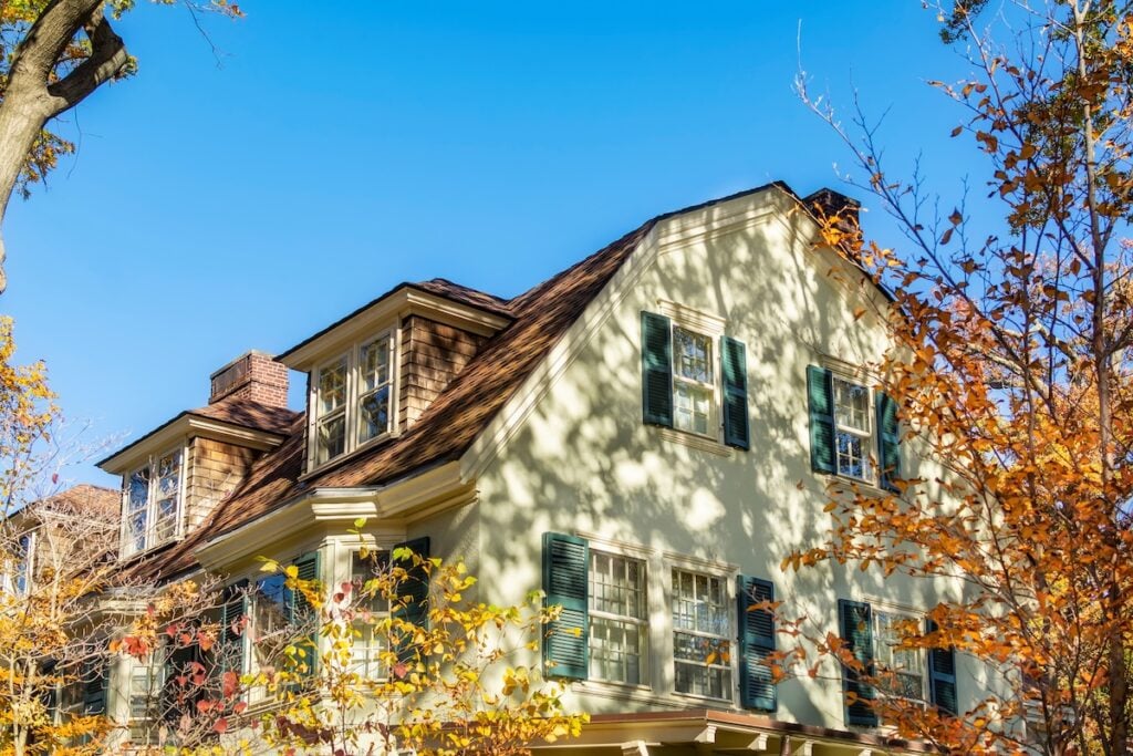 Gambrel roof on a family home with asphalt roofing shingles