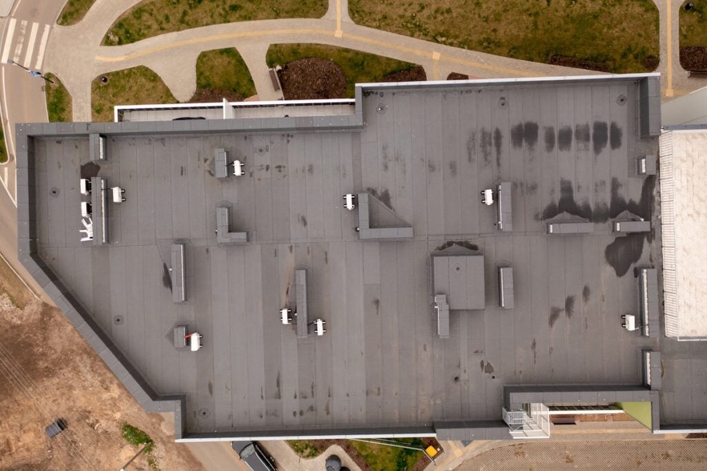Drone photography of apartment complex rooftop during summer day