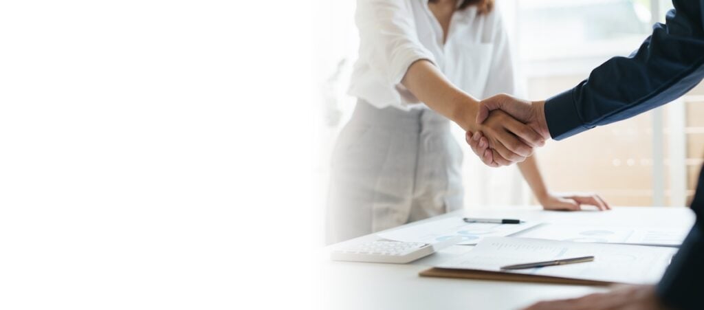 Business partnership man and woman shaking hands