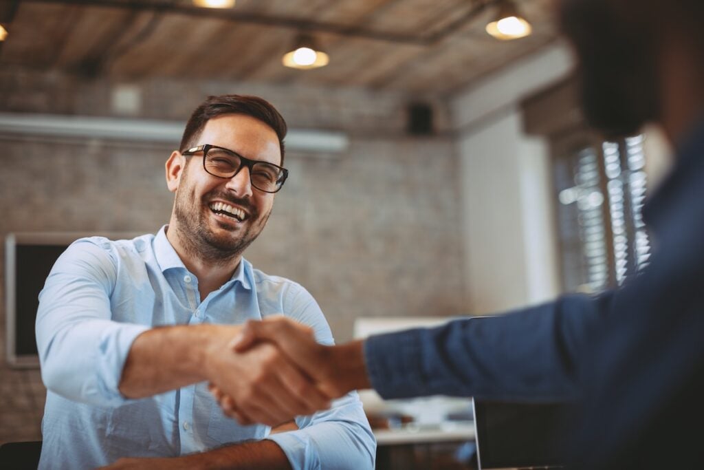 Close up of handshake man in glasses