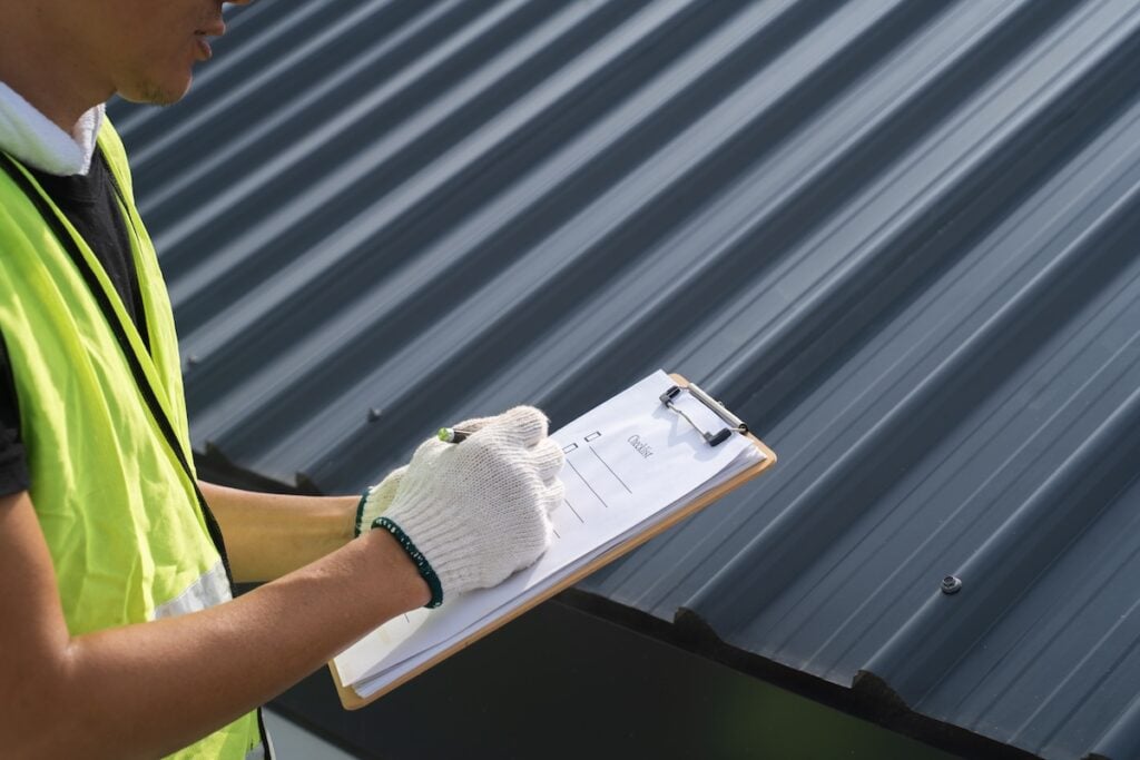 worker inspecting rooftop