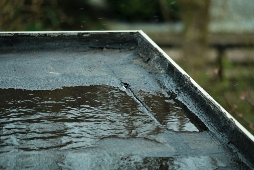 rain pooling on flat commercial roof