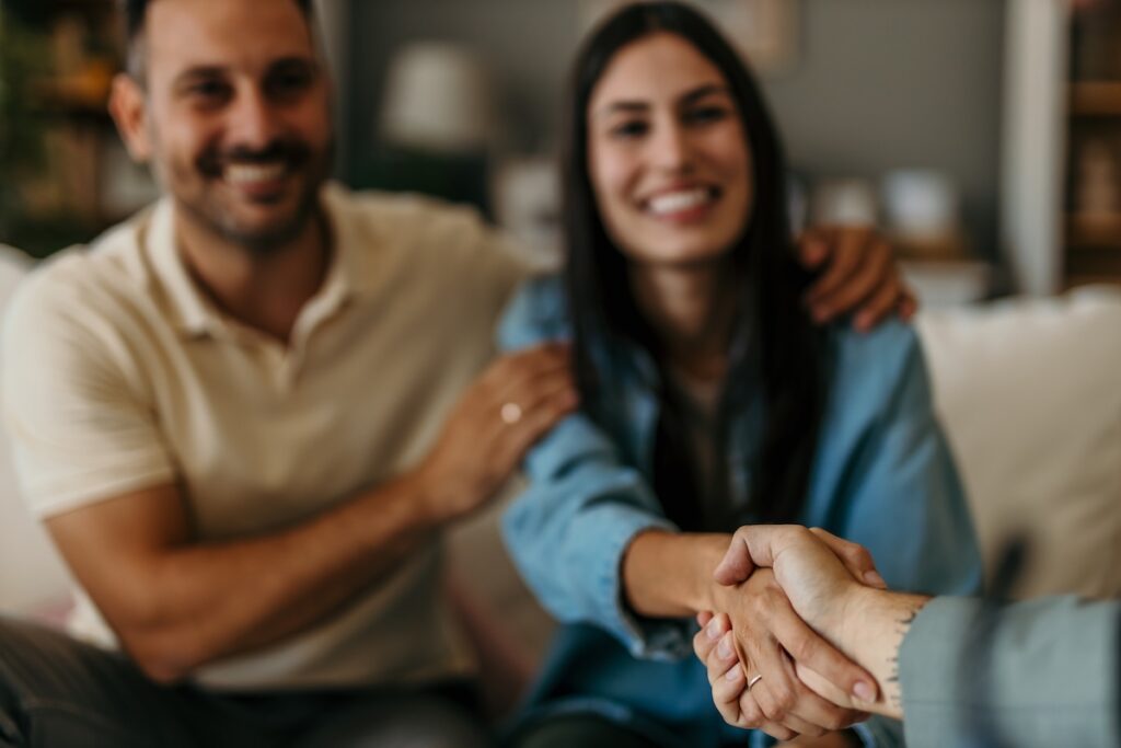 Happy man and woman clients handshake close deal
